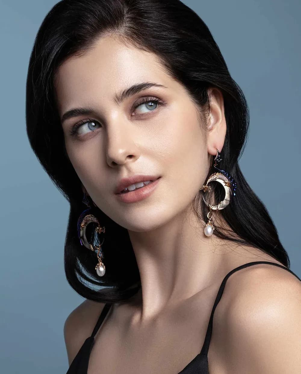 Handcrafted earrings worn by a model